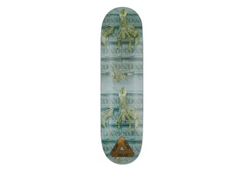 Palace Powers No Two 8.5 skateboard deck: Greenish photographic image of a pale gold sculpture of a winged, tailed figure repeated twice over a background of repeating banknote text reading 'NO', with the Palace tri-ferg logo in gold at the tail.