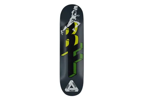 Palace Pro Ferg Fairfax 8.1 skateboard deck: Dark grey deck with a monochrome photo cut-out of a running athlete leaping over large 3D block letters in yellow and green. The Palace tri-ferg logo sits at the bottom with the rider name.