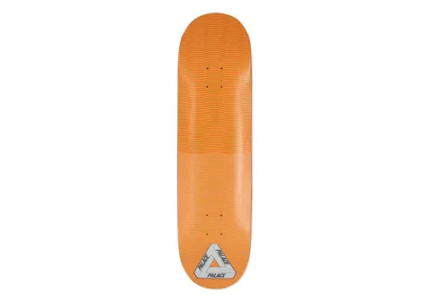 Palace Trippy Stick Three Orange 8.5 skateboard deck: Orange deck with a fine wavy-line optical pattern across the surface, shifting tone at the middle. Palace tri-ferg logo in silver at the bottom.