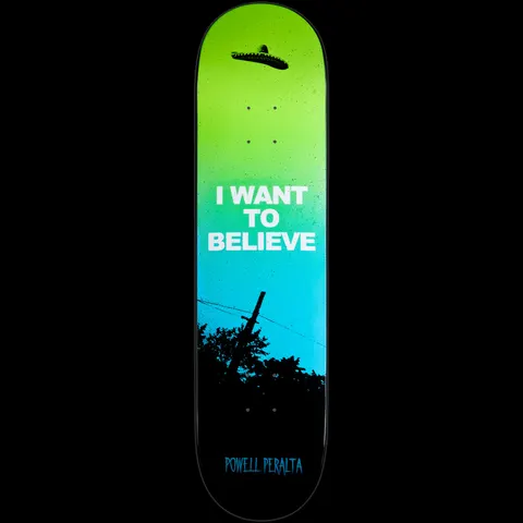 Powell Peralta LIGAMENT Believe skateboard deck: A green-to-blue gradient sky with a sombrero floating like a UFO above silhouetted trees and a telegraph pole, with the slogan in white block capitals.