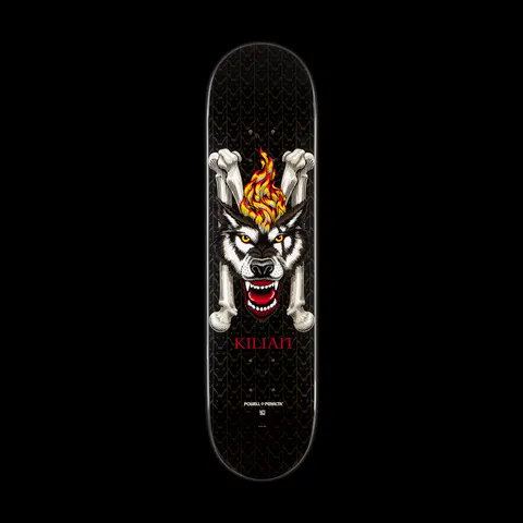 Powell Peralta LIGAMENT Pro Kilian Martin Wolf skateboard deck: Snarling wolf head with a flame rising from its forehead, framed by two crossed bones, on a black deck with a subtle chain-link pattern. Rider name in red below and Powell Peralta logo at the tail.