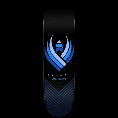 Powell Peralta Mike McGill Flight - Shape 218 skateboard deck: A blue abstract winged emblem in layered shades of blue on a black deck, with Flight and Mike McGill lettered below and a blue chevron line pattern across the tail.