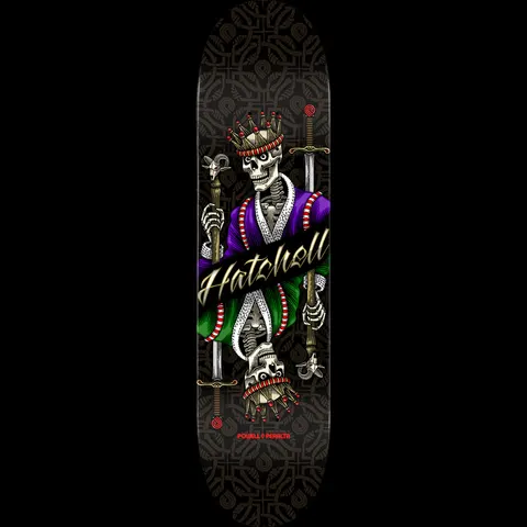 Powell Peralta Pro Ben Hatchell King - Shape 247 skateboard deck: Double-headed skeleton king in a purple and green robe wearing a crown, in playing-card style, holding a sword and sceptre. 'Hatchell' script across the middle, on a black deck with a faint patterned background.