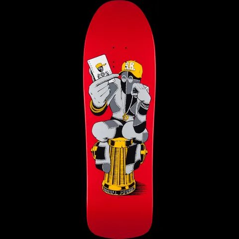 Powell Peralta Ray Barbee Hydrant skateboard deck: A patchwork-stitched figure in a yellow cap with initials, face mask and gold chains crouches on a gold fire hydrant, holding up a playing card, on a red old-school shaped deck. Brand name sits at the base of the hydrant.