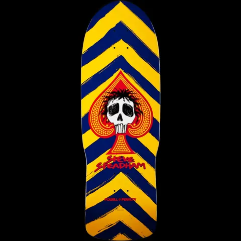 Powell Peralta Steve Steadham Skull and Spade Blue/Yellow skateboard deck: Old-school shape deck with bold navy and yellow chevron stripes, a red spade at the centre holding a skull with spiky dark hair, and the rider's name in red brush lettering below.