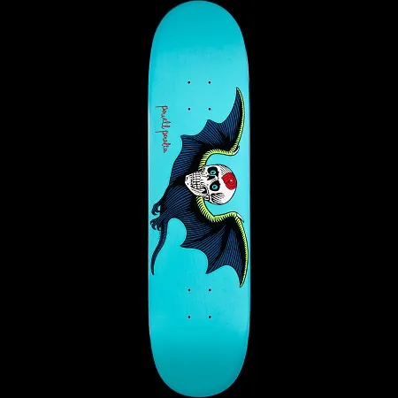 Powell Peralta Bat Skull Turquoise skateboard deck: White skull with teal eyes and a red mark on the forehead, held in a dark blue bat's wings edged in lime green, on a turquoise deck with a small red Powell Peralta signature.