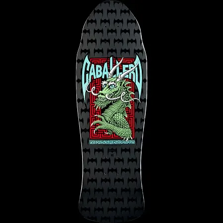 Powell Peralta Caballero Street Silver skateboard deck: Old-school shaped black and grey deck with a repeating bat pattern and a central graphic of a green dragon over a red maze pattern, with CABALLERO in teal winged lettering above.