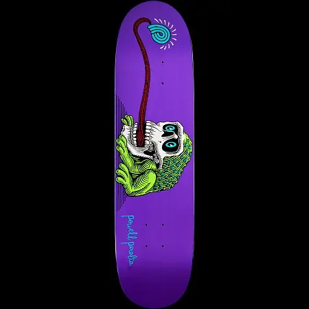 Powell Peralta Frog Skull skateboard deck: A green frog crouches inside a white skull, its long red tongue stretching up to a blue spiral lollipop-like swirl, on a purple deck. Powell Peralta signature in blue script near the tail.