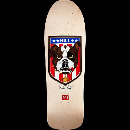 Powell Peralta Hill Bulldog skateboard deck: A shield with stars and red and white stripes holding a brown and white bulldog head with a bone on its brow and a sheriff star below. Signature beneath and a red 911 badge, on a natural maple old-school shaped deck.