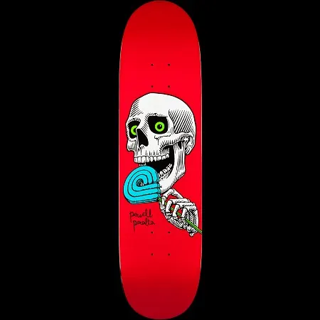 Powell Peralta Lolly P Red skateboard deck: Wide-eyed white skull with green eyes licking a blue swirled lollipop held in a skeleton hand, on a red deck. Powell Peralta in small black handwriting beside it.