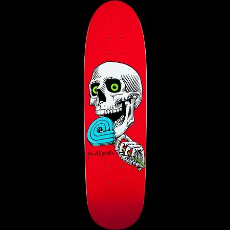 Powell Peralta Slappy Lolly P skateboard deck: Illustrated white skull with wide green eyes and open jaw, licking a blue swirl lollipop held by a skeletal hand, on a solid red deck with a handwritten logo.