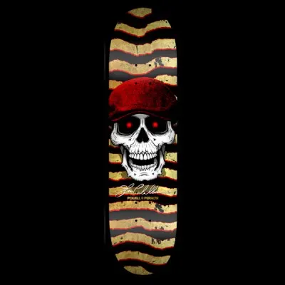 Powell Peralta Caballero Hooligan - Black/Gold skateboard deck: White skull with glowing red eyes wearing a red flat cap, over ripped zigzag stripes in gold and black edged with red. Signature and Powell Peralta text below.