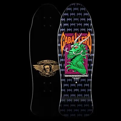 Powell Peralta Caballero Street - Black/Purple skateboard deck: A green dragon with white horns rises inside a pink maze border under the name in orange bat-wing lettering. A pattern of grey bat shapes covers the black deck, and the underside shows a winged skull logo.