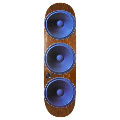 Quasi Barker Speakerhead skateboard deck: Brown wood-stained deck with a photographic print of three large blue speaker cones stacked down the length of the board. A small black label sits beside the lowest speaker.