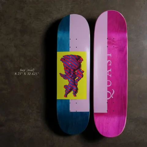 Quasi Boy8.75 - Teal skateboard deck: Yellow panel containing a sculpted figure covered in red and blue stripes, set on a split teal and pale pink deck. The underside is bright pink with the brand name in large letters.