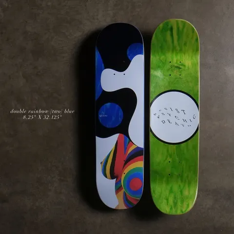 Quasi Double Rainbow - Blue skateboard deck: White and black abstract shapes with deep blue circles above a woman's torso painted in rainbow stripes. Underside in green with a white circle reading 'Resist Psychic Death' in wavy text.
