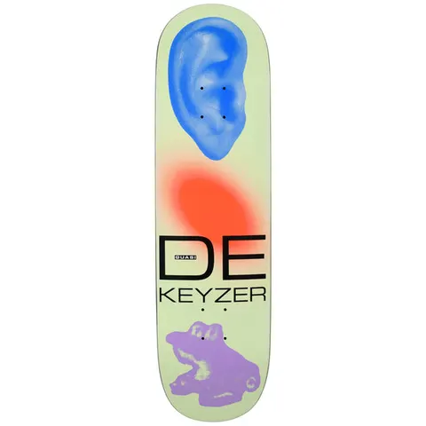 Quasi de Keyzer Ear skateboard deck: Pale green deck with a blue human ear at the top, a blurred orange blob in the middle, 'DE KEYZER' in black capitals with a Quasi label, and a purple toy frog or car silhouette at the tail.