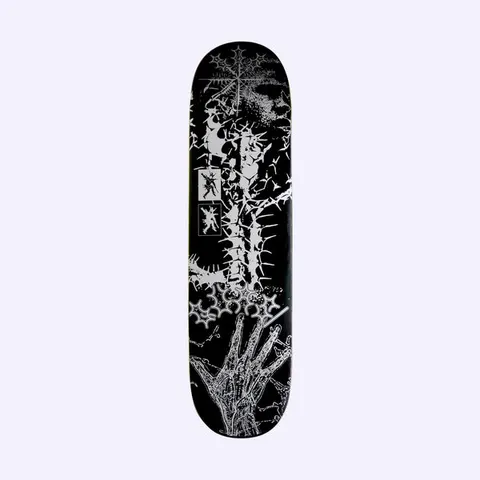 Quasi de Keyzer Monochrome skateboard deck: Silver-on-black collage of thorny branches forming a cross-like shape, spiked star motifs, small framed figures and a skeletal hand reaching up from the tail.