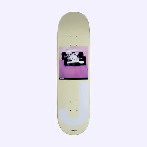 Quasi Henry Big J skateboard deck: Cream deck with a square pink-toned photo of an open-wheel racing car head-on, a black caption bar reading Henry, and a huge pale lilac letter J below, with the Quasi logo at the tail.