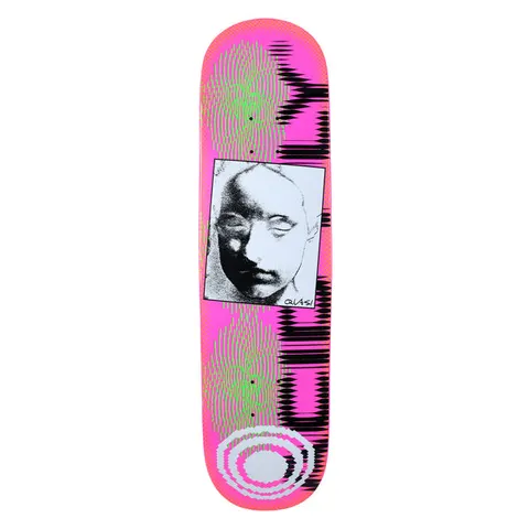 Quasi Reubens skateboard deck: Neon pink deck with a framed black and white grainy photo of a blank-eyed plaster face at the centre. Green halftone ripples sit above and below, a black jagged waveform down the right edge and a pale ring logo at the tail.