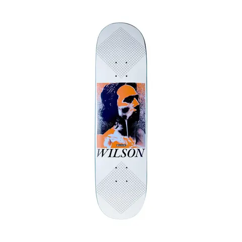 Quasi Wilson Skin Care skateboard deck: A grainy orange and navy portrait of a long-haired man, with a melting drip over part of his face, sits in a square panel. Grey grid-pattern diamonds cover the nose and tail of the white deck, with the surname in serif type below the portrait.