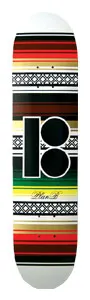 Plan B Ricos skateboard deck: Horizontal bands of woven blanket-style stripes in red, black, green, yellow and gold, with lattice patterned strips, and a large black Plan B logo in the centre on a white deck. Small script signature below.