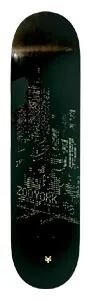 Zoo York Big City Lights skateboard deck: Dark night-time city skyline of lit tower windows in tiny gold dots on a black deck, with ZOO YORK lettering and a small gold logo at the tail.