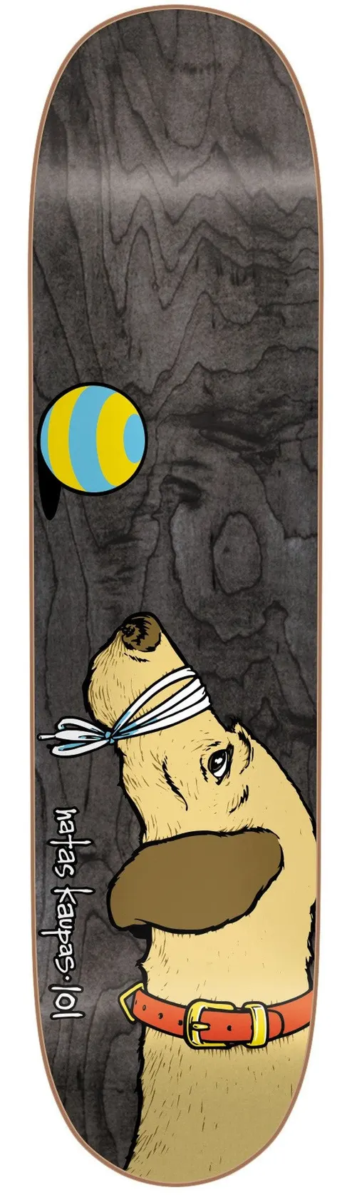 101 Heritage Natas Dog Sp skateboard deck: Grey wood-grain deck with a cartoon dog with a blindfold and orange collar looking up at a blue and yellow striped ball. Natas Kaupas 101 written along the side.
