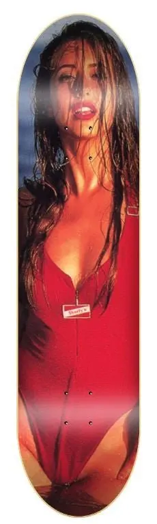 Shorty's Rosa BIG Brother Cover skateboard deck: Full-deck photograph of a woman with long wet hair in a red zip-front swimsuit, shot against a dark blue-grey sky. A small Shorty's label is on the swimsuit zip.