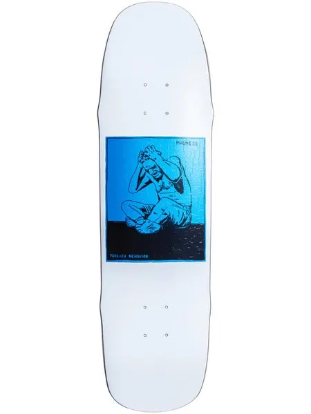 Madness Stressed (White Blue) skateboard deck: Blue and black square print on a white shaped deck showing a seated figure gripping their head in distress, with small Madness lettering at the corner and 'Foolish Behavior' at the bottom.