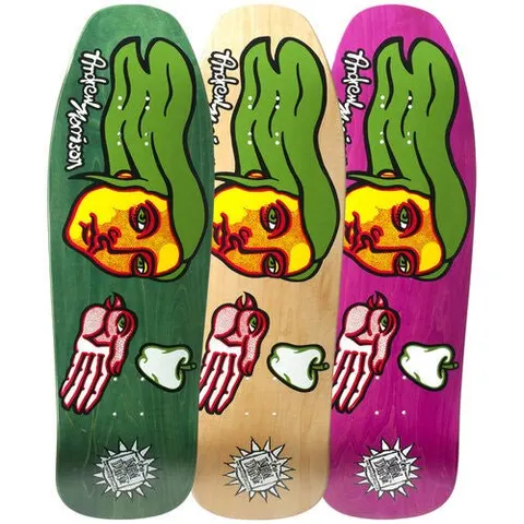 New Deal The Morrison Bird Hand Screenprinted skateboard deck: Side profile of a yellow face with long green hair, above a pink hand with a bird's head and a white pepper-like shape, with a sunburst logo at the tail. Shown in three stain colourways: green, natural and purple.