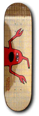 Unknown Templeton Jesus skateboard deck: Red cartoon monster with a black open mouth, a single eye and two long clawed arms reaching across a gold deck with a faint grid texture. Tiny red text sits along the lower edge.