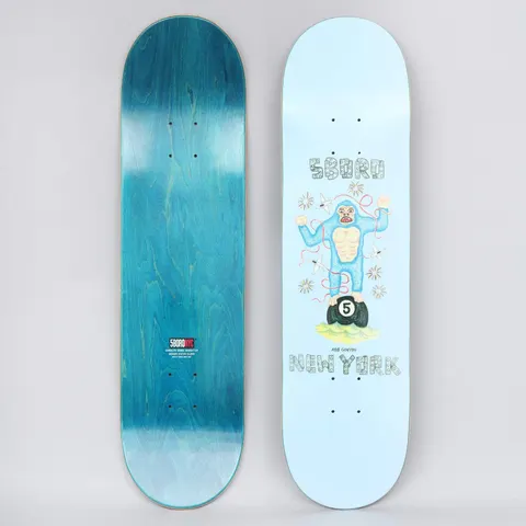 5Boro X Ds 8.25 Rob Ganyon Blue skateboard deck: Naive crayon-style drawing of a blue gorilla standing on a black number 5 pool ball, with planes and fireworks around it, between 5Boro and New York in decorated lettering on a pale blue deck. Teal underside with a red 5Boro NYC logo is also shown.