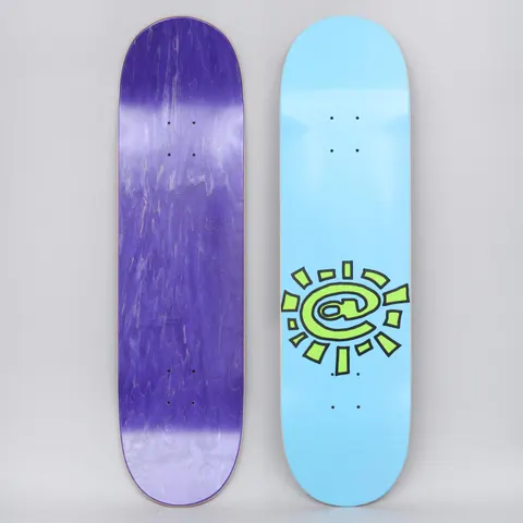 Always @Sun Blue skateboard deck: A lime green sun with an @ symbol at the centre, outlined in black with ragged rays, set low on a plain light blue deck.