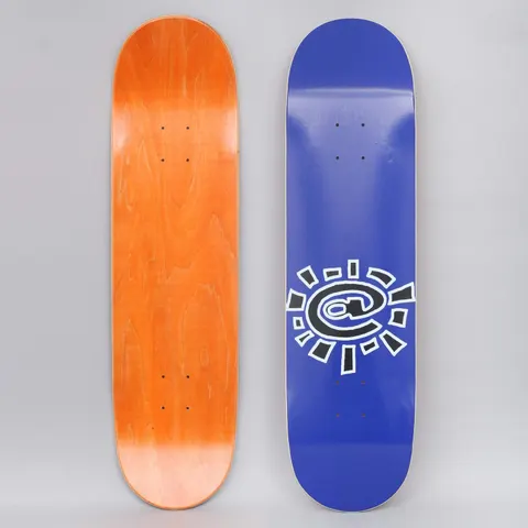 Always @Sun Navy skateboard deck: Navy blue deck with a large black and white outlined @ symbol drawn as a sun, with rays around it, placed low on the board. The underside shows orange-stained wood.
