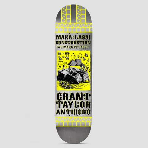 Anti Hero Grant Makalassi Construction Re-Color DBX Silver skateboard deck: Silver deck with yellow brick-pattern borders and a yellow panel showing a line drawing of workers hauling a large block near pyramids with hieroglyphs. Black blackletter text above and below.