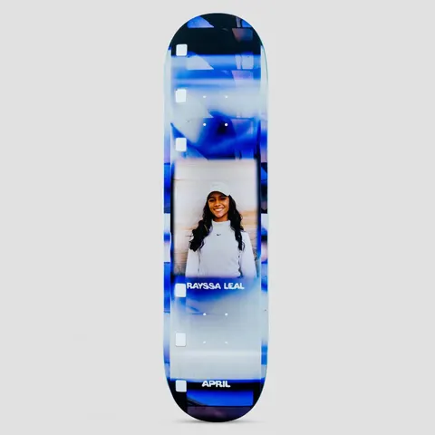April Rayssa Leal 2023 skateboard deck: Photo of a smiling woman with long dark hair in a white cap and top, framed by a blurred blue and white film-strip border with sprocket holes. Rider name and APRIL appear on the deck.