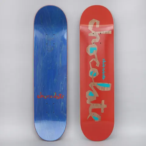 Chocolate Roberts Original Chunk V2 Dark Red skateboard deck: Large lettering of the brand name in a chunky cut-out style, showing natural wood through a red surface with teal accents, with the rider name in small teal text. The photo also shows the blue underside.