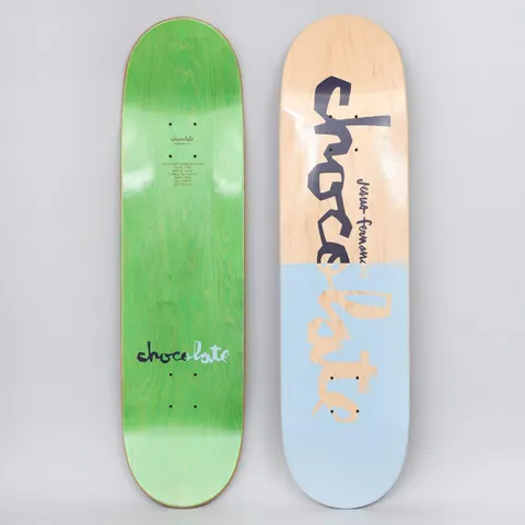 Chocolate Jesus Fernandez Original Chunk Natural / Blue skateboard deck: Large hand-lettered Chocolate 'chunk' logo in navy across the top half on bare natural maple, while the lower half is a pale blue block with the lettering showing through in wood tone. A rider name is written small beside the logo.