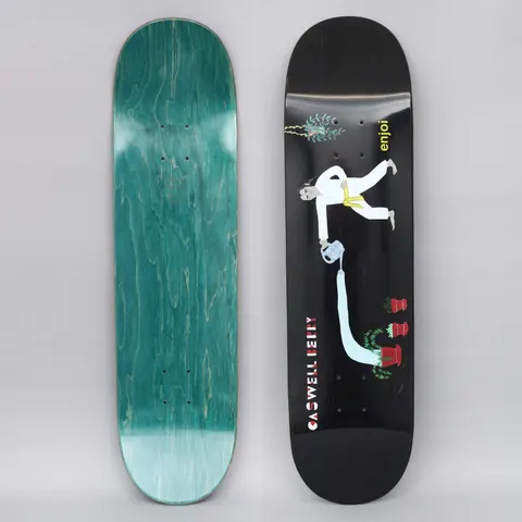 Enjoi Caswell Over Board R7 Black skateboard deck: Illustration of a man in a white karate suit with a yellow belt, leaning over to pour water from a can in a long stream into red plant pots. A hanging plant sits at the top, on a plain black ground.