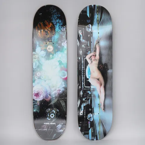 Evisen Naked Defense skateboard deck: Two decks shown. One has a bloom of pastel flowers and an orange tulip on black, the other a reclining nude woman in a futuristic corridor of buildings under a blue light. Artist credit at the base.