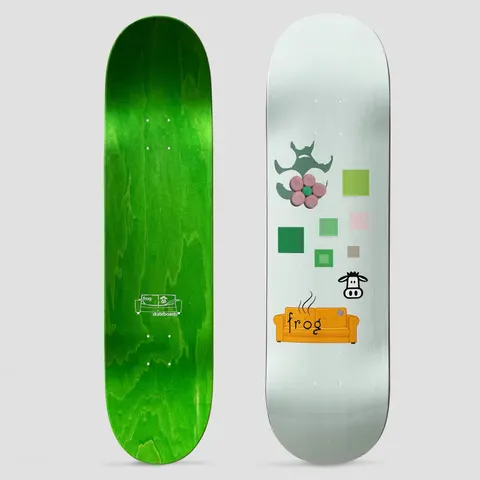 Frog Stinky Couch skateboard deck: Pale mint deck with a few simple graphics: a pink flower with a green centre under a dark green splat shape, scattered green and pink squares, a small cartoon cow face and an orange steaming couch carrying the frog name.