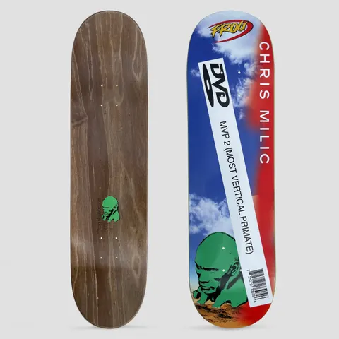 Frog Chris Milic Dwayne skateboard deck: A green stone-like head sunk in desert sand below a blue sky with clouds, with a white DVD-case style label reading MVP 2 (MOST VERTICAL PRIMATE) and a barcode across it. CHRIS MILIC runs in white down a red edge, with a Frog logo at the top.