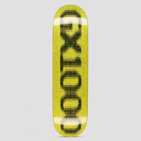 GX1000 OG Logo Blur Yellow skateboard deck: Yellow deck with the GX1000 logo in black capitals, heavily blurred and pixelated as if smeared in motion, with white blur highlights. Runs vertically along the board.