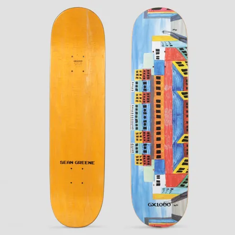 GX1000 Sean Green City skateboard deck: Naive painted cityscape of colourful blocks of flats with black windows and yellow awnings, stacked symmetrically against a blue sky, with the GX1000 logo near the tail.