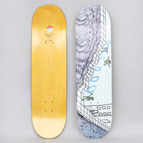 GX1000 Turtle White skateboard deck: Hand-drawn pen illustration of a tiled bowl or wall with a scribbled grey rock face, and two small green turtle skaters riding it. Blue bubble-style 'GX1000' lettering runs down the edge.