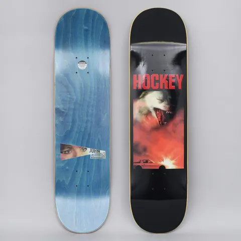 Hockey John Fitzgerald Corvette Black skateboard deck: Red-toned photographic image of a snarling white wolf or dog above a white sports car with a bright flash, beneath a red Hockey logo, on a black deck. The underside has a cut-out eye photo labelled John.