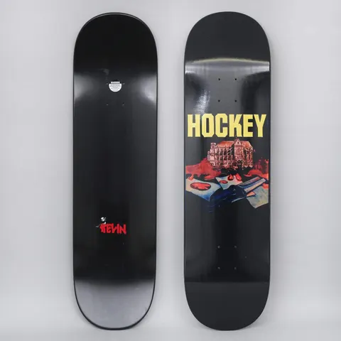 Hockey Kevin Rodriguez St. Kev Black skateboard deck: Painted scene of an ornate gothic building above blood-red splashes and an open book or papers with a dark hand, on a black deck under a large yellow Hockey logo. A small red Kevin signature appears on the underside.