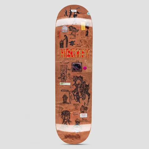 Hockey Paper Cover Diego Todd Board Shape 2 skateboard deck: A brown paper-bag textured deck covered in small collaged scribbles, stickers, tiny drawings and notes, with a red and gold Hockey logo across the middle and a small framed picture of a planet below it.