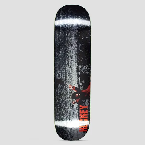Hockey Kevin Rodrigues Prey skateboard deck: Dark, grainy black and white texture with two bright horizontal glare bands. A small figure in red with arms outstretched lies low on the right, with Hockey in red capitals running up the lower edge.